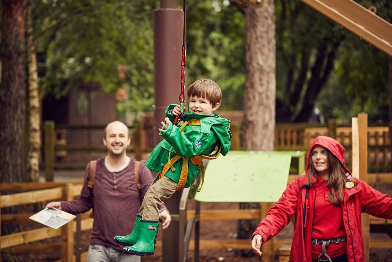 Young person zip lining across the Mini Trek course.