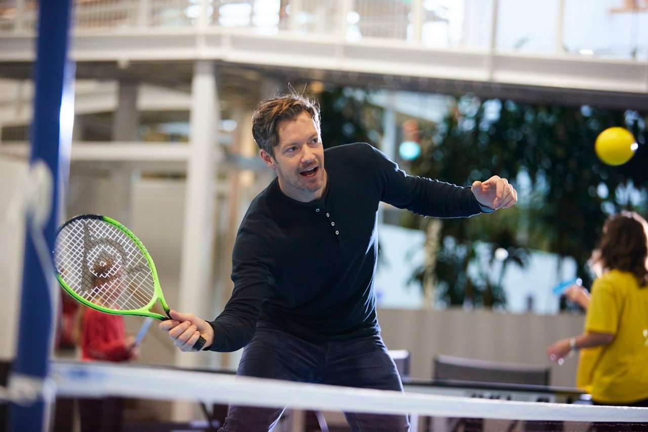 A man swinging his racket ready to hit the ball 