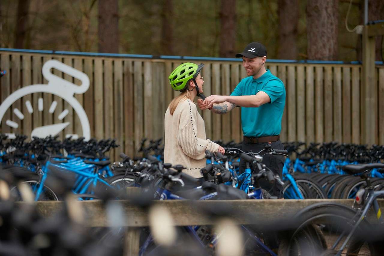A girl having her helmet fitted.