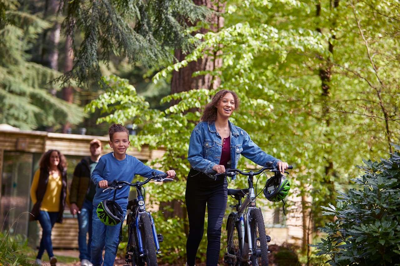 Family walking with their bikes.