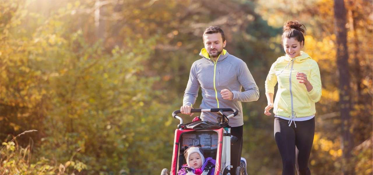 couple jogging with pushchair