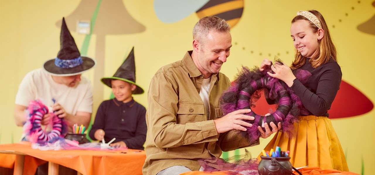 Father and daughter taking part in creepy crafts