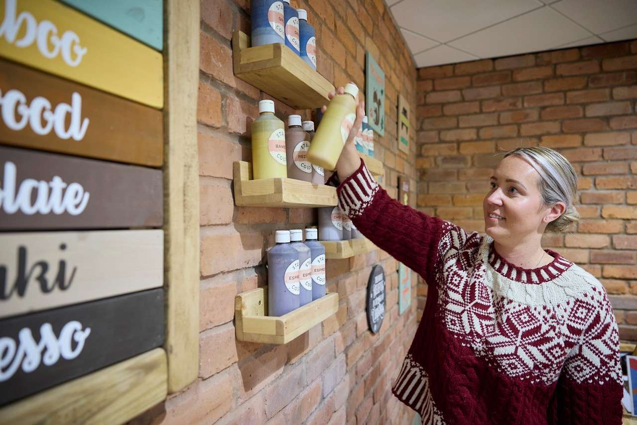 Woman choosing paint colours.