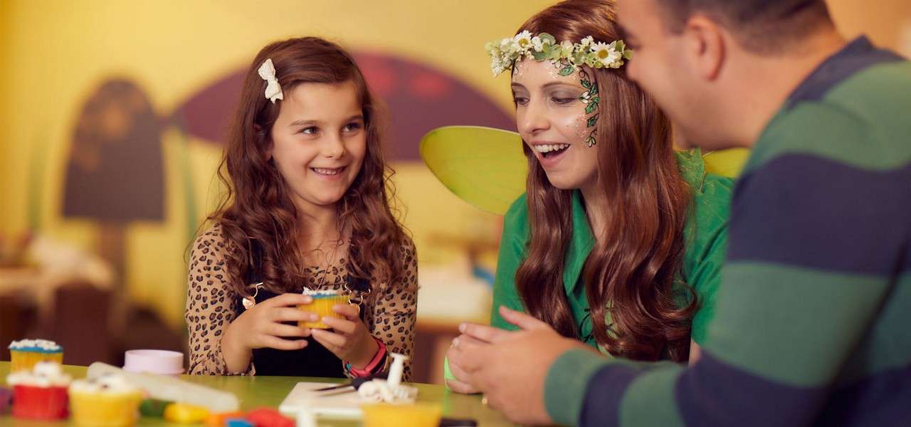 Young girl taking part in cupcake decorating 