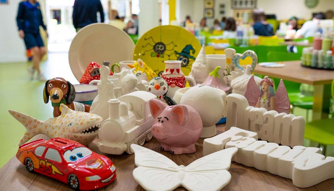 A collection of pottery items including, dog, train, pig, car.