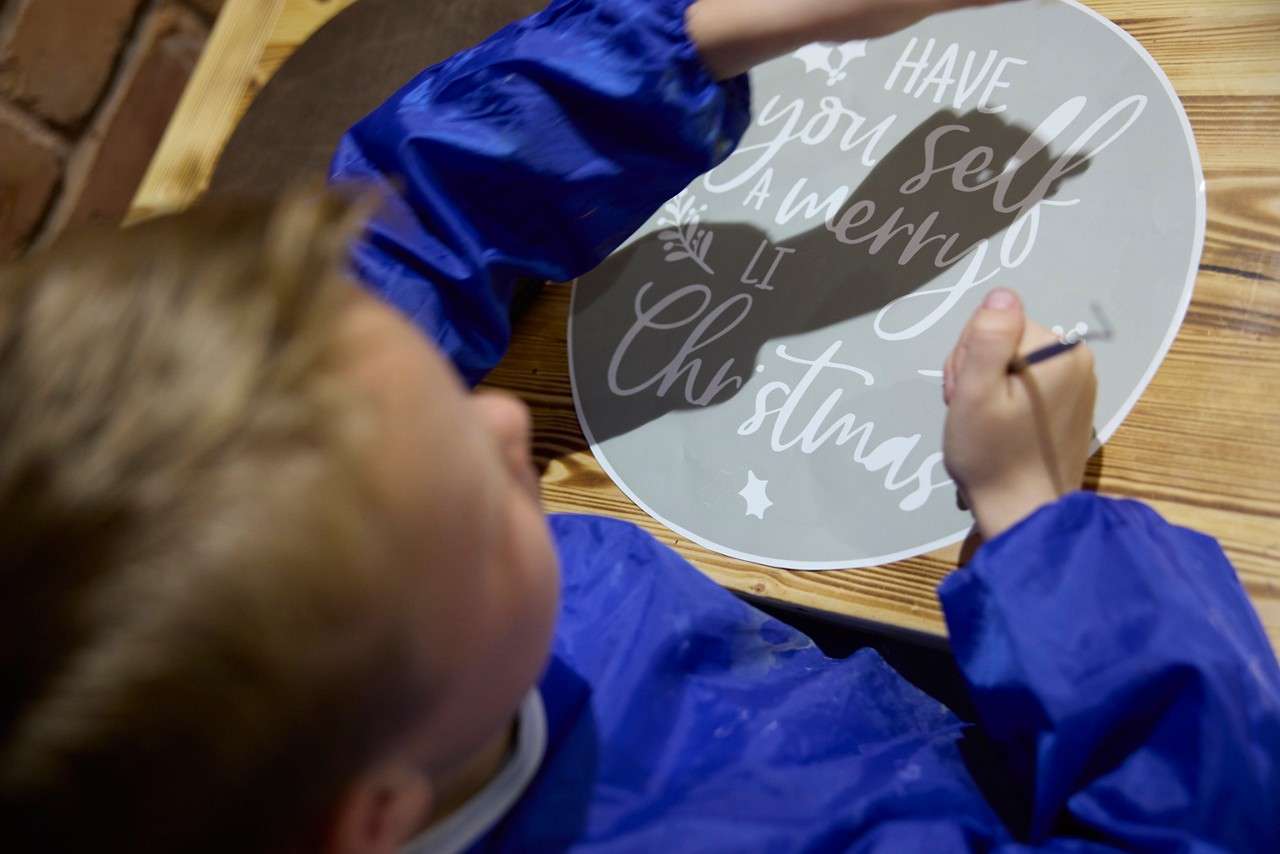 boy designing woodcraft piece