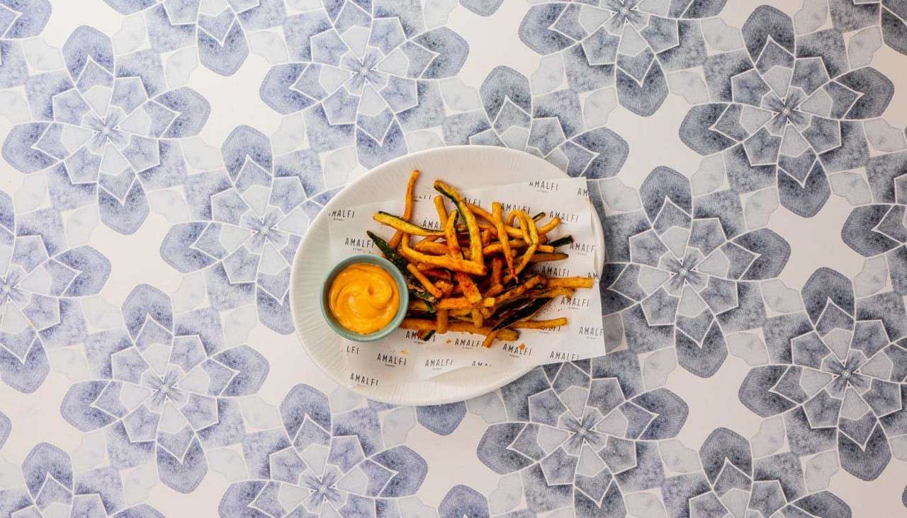 A plate of Zucchini Fritti served with chorizo mayo dip