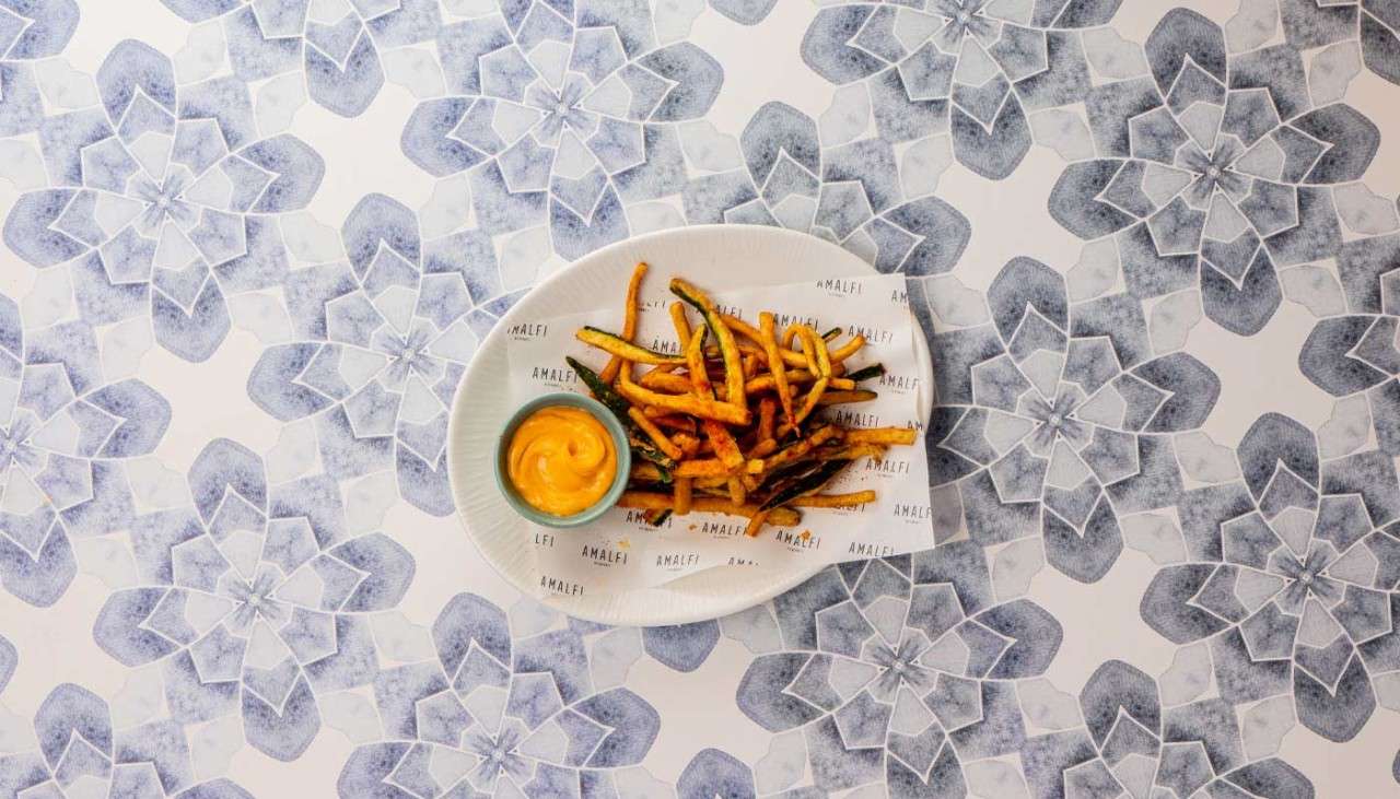 A plate of Zucchini Fritti served with chorizo mayo dip