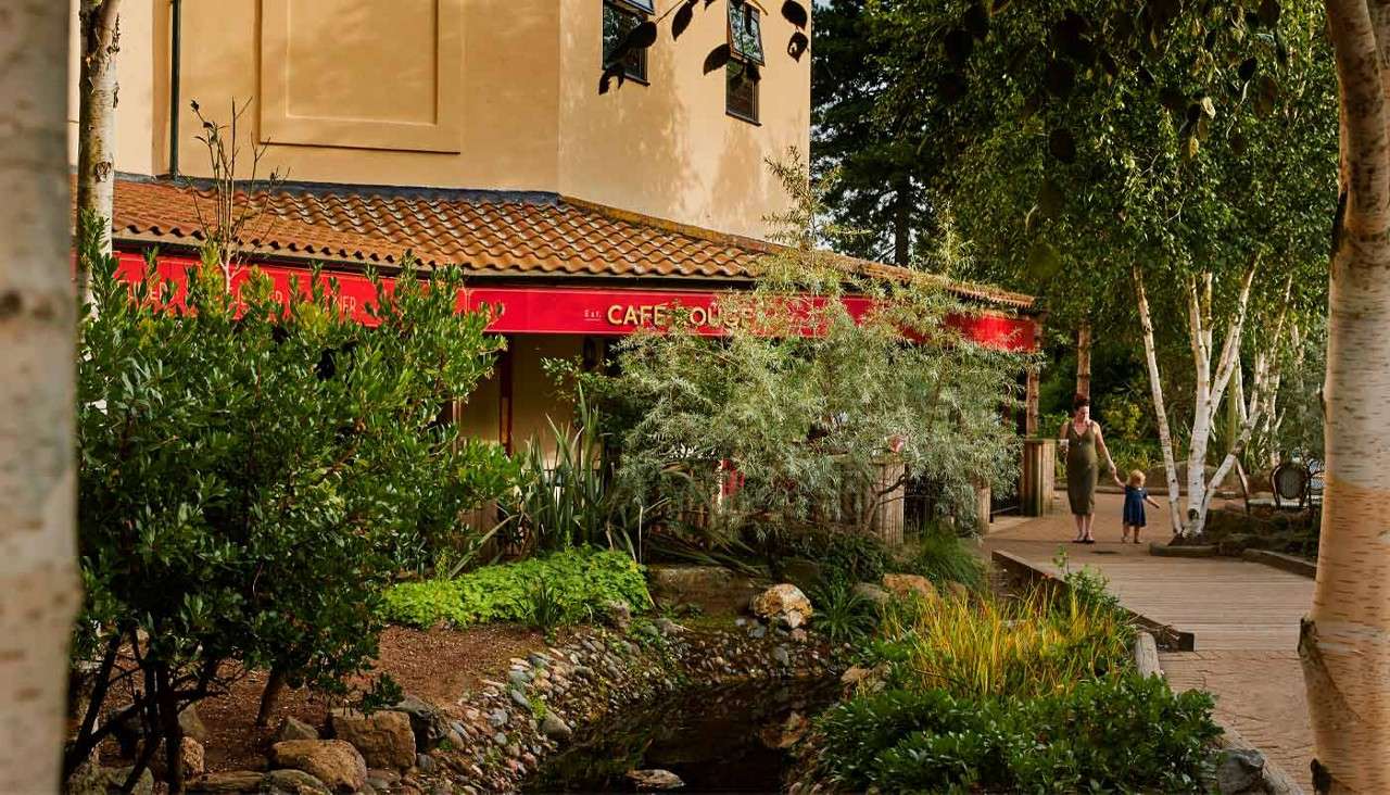 Exterior of Cafe Rouge surrounded by bushes.