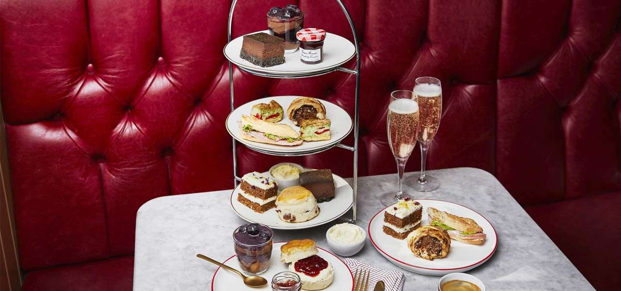 Afternoon Tea platter stacked with sweet and savoury treats.