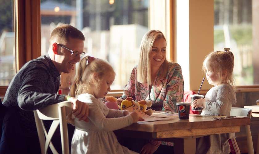 Family sitting around a table in Huck's. 