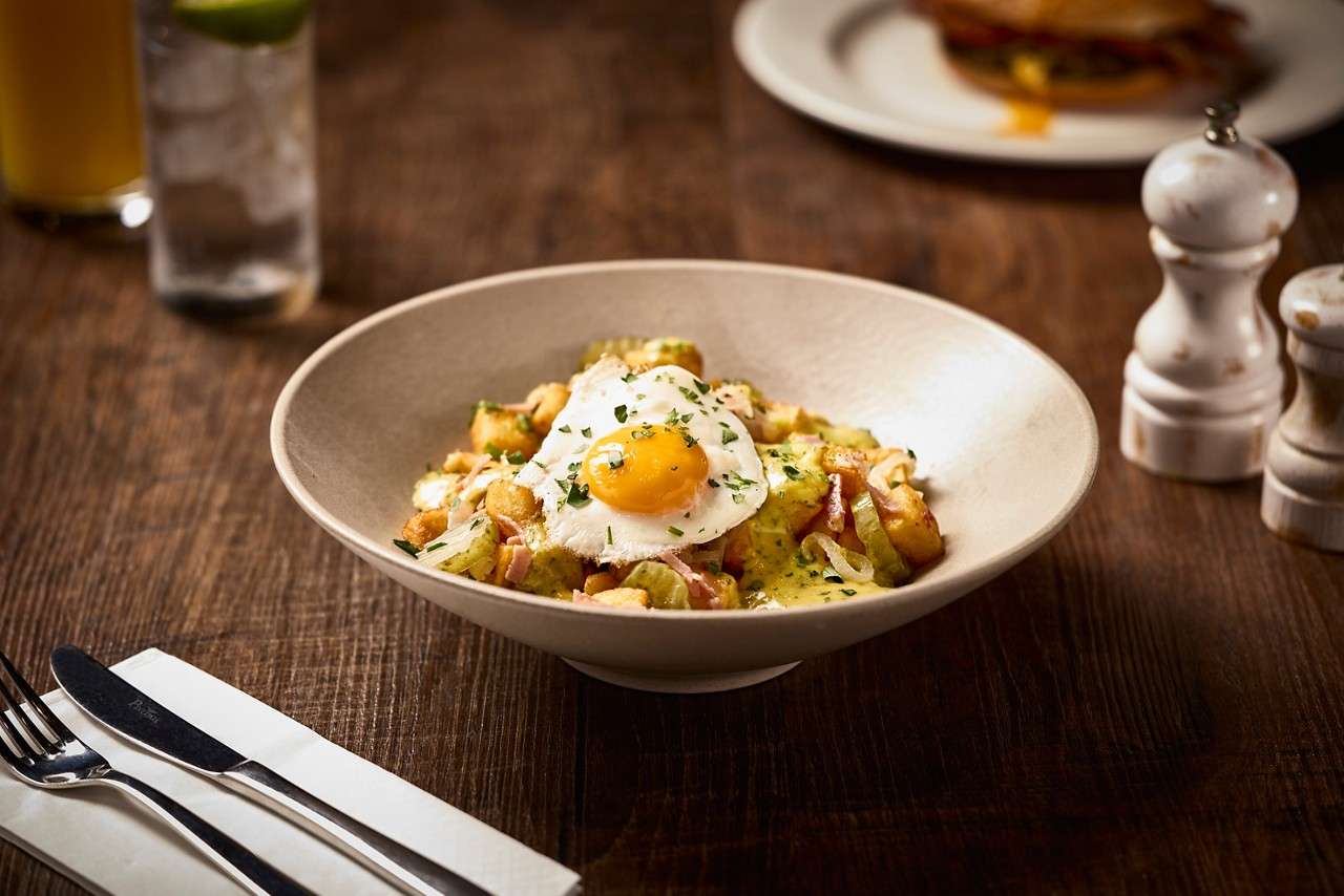 New York Deli Pastrami Hash, topped with a fried egg.