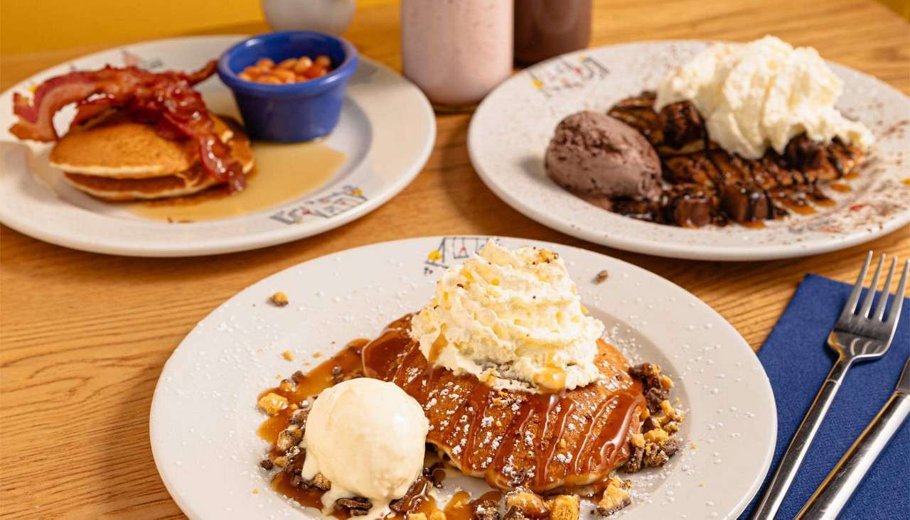 Pancakes stacked with a variety of toppings.