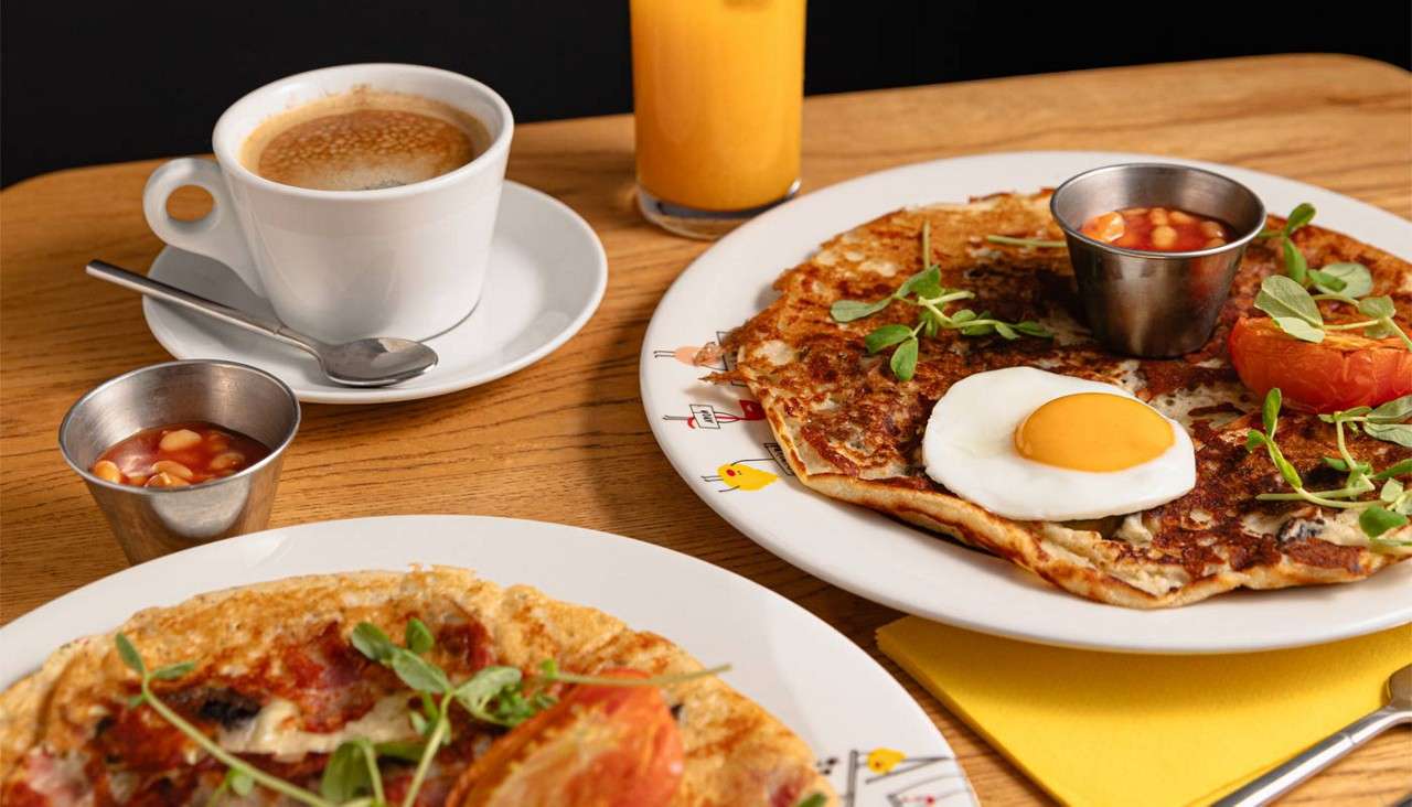 Omelette topped with breakfast items.