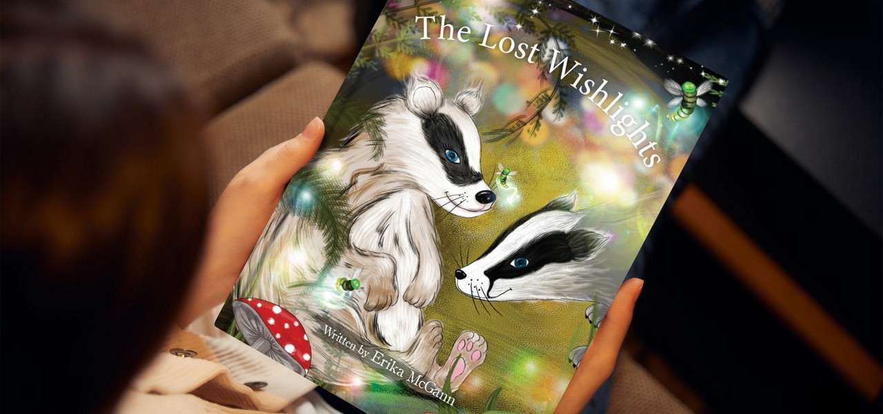 Young girl holding a book with an image of a badger titled 'The Lost Wishlights'