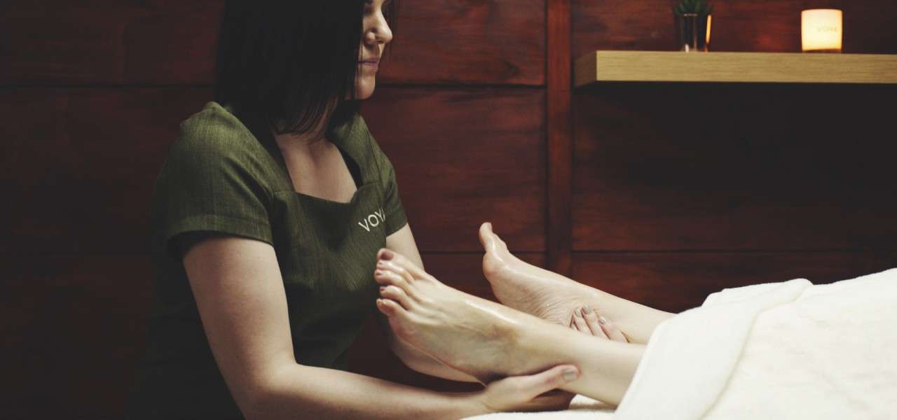 Woman massaging a pair of feet