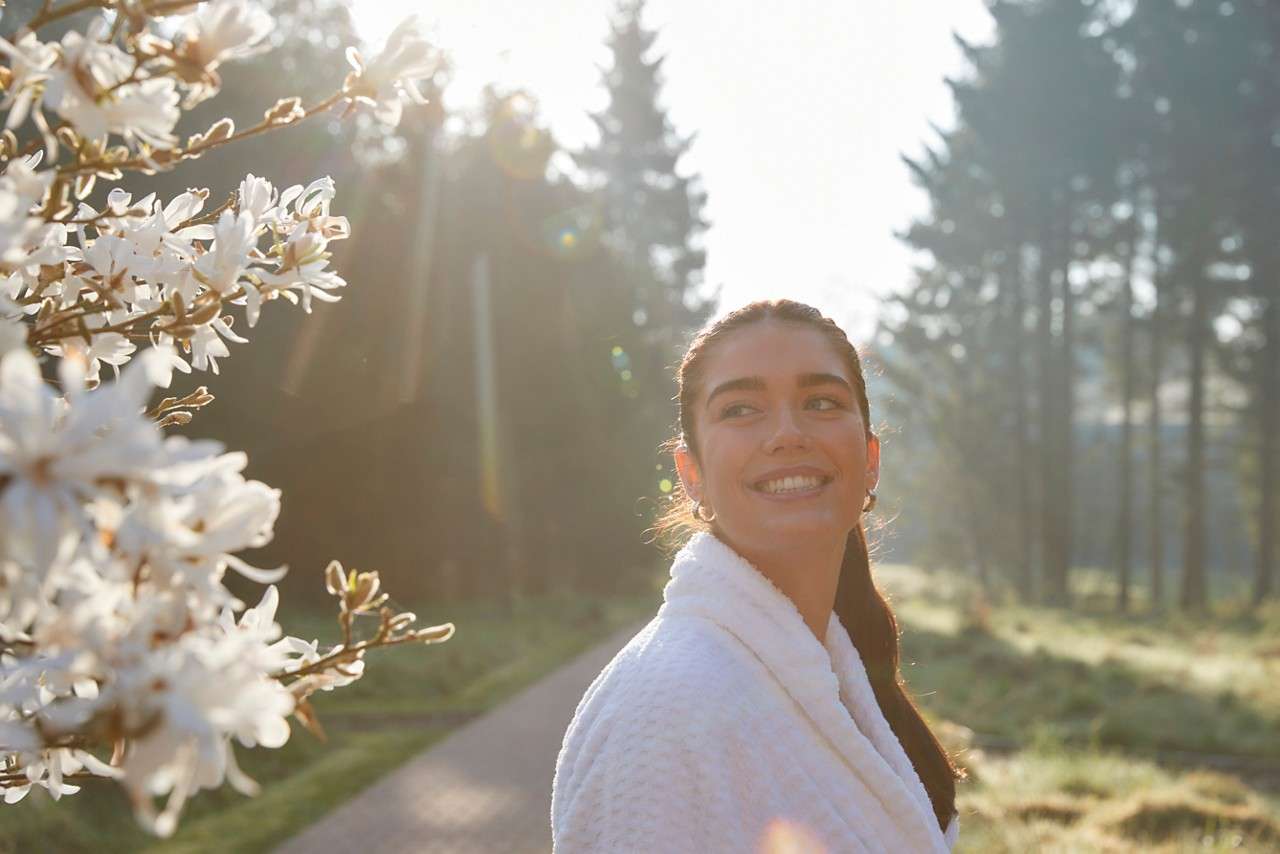 women outside by blossom tree