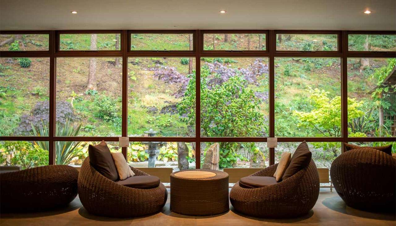 Two comfortable chairs looking out to a Japanese inspired Zen Garden