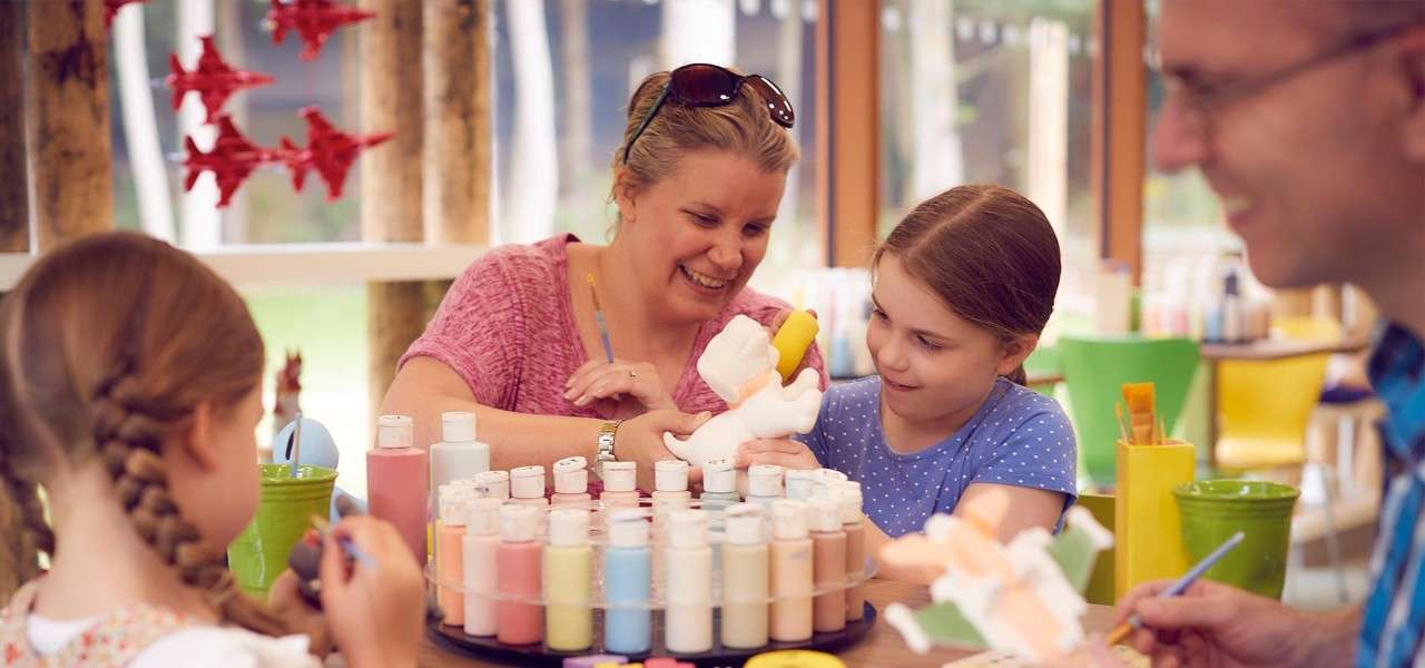 Family painting pots in the pottery studio