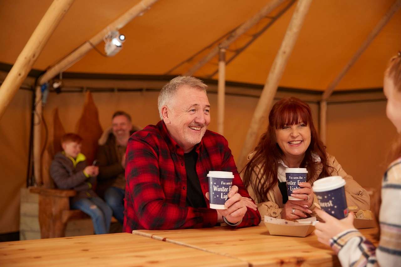 Two people sitting in the tipi