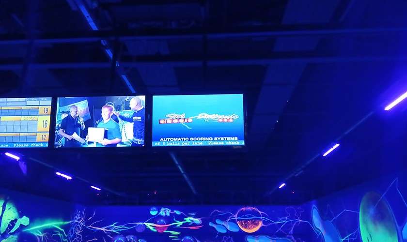 A group of screens above the lane