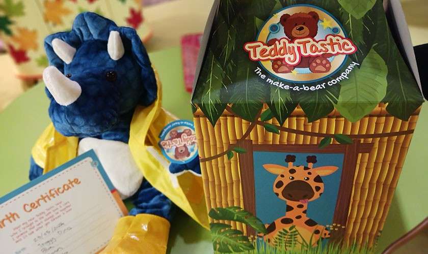 The finished teddy next to a big colourful box