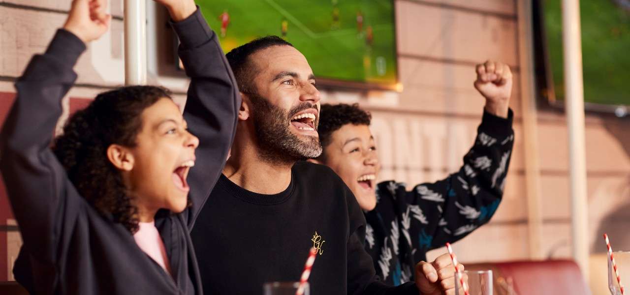 A father and sons cheering 