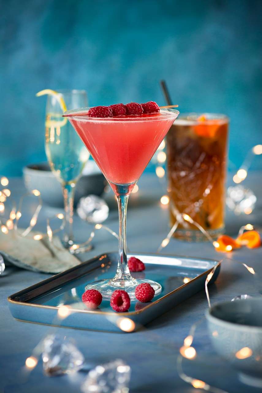 Festive cocktails topped with fresh fruit.