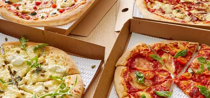 Freshly baked pizza's in takeaway boxes.