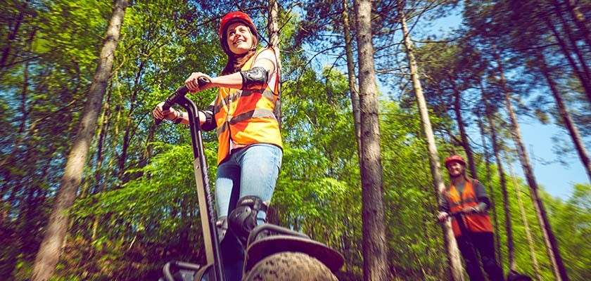 Women on segway riding through the forest