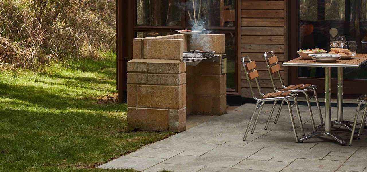 A barbeque outside a lodge in the forest