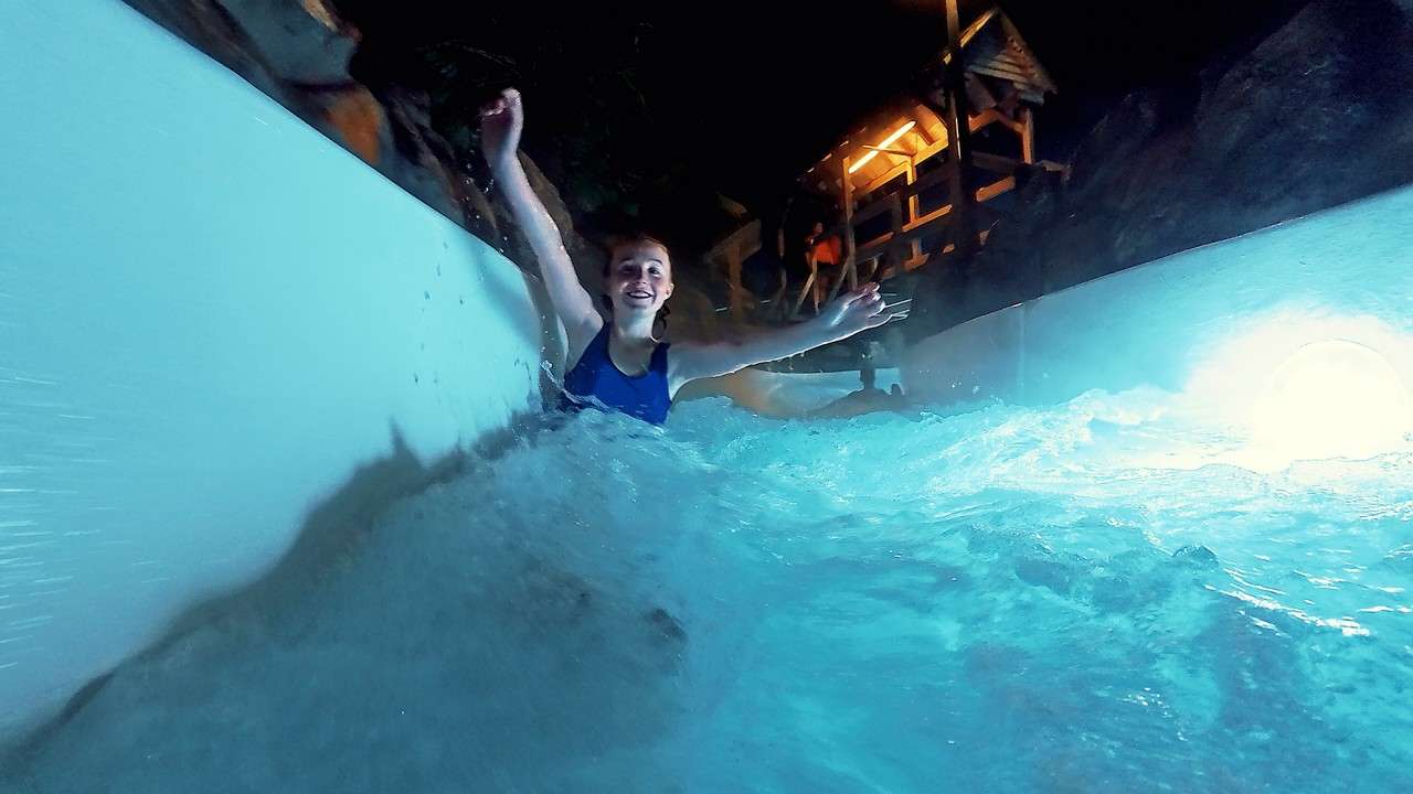 Young person going down the Wild Water Rapids.