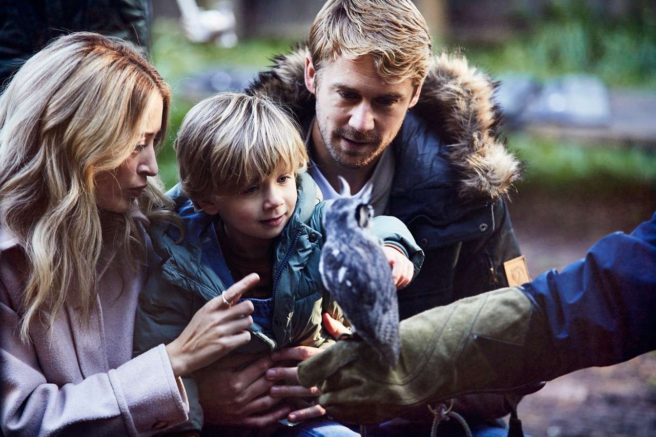Family holding a Baby Owl.