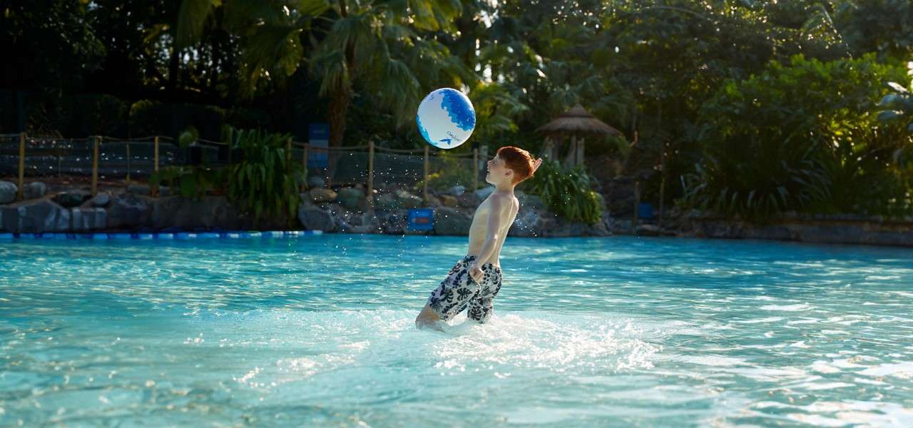 A boy splashing in the pool