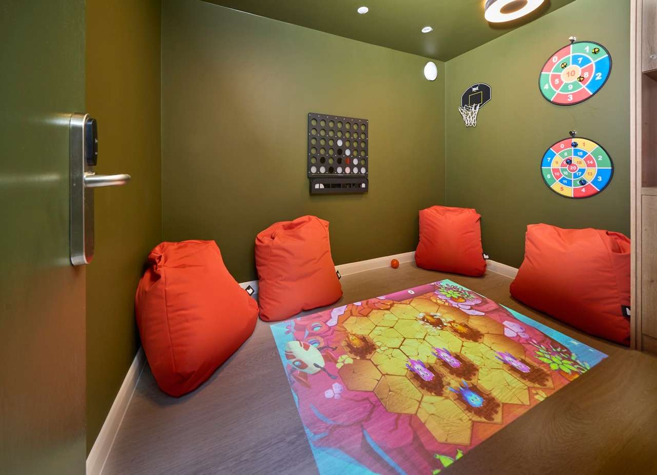 Interactive games pod with bean bags and projector.