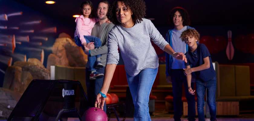 A woman bowling.