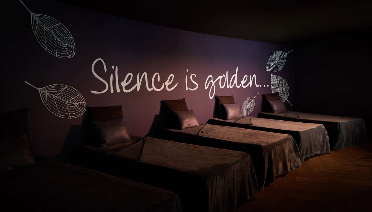 Text: ' Silence is golden'. Water beds in a relaxing darkened room.