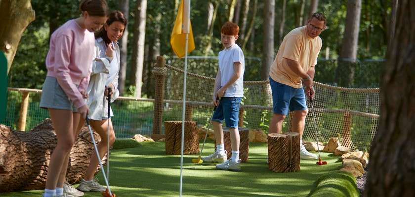 Family playing a round of Adventure Golf.