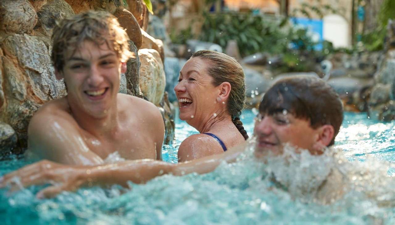 Teenagers and their mother riding down the rapids of the Subtropical Swimming Paradise.