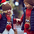 Family walking through Winter Wonderland children wearing jumpers with Rudolf on them