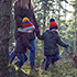 Children running through a wintery forest