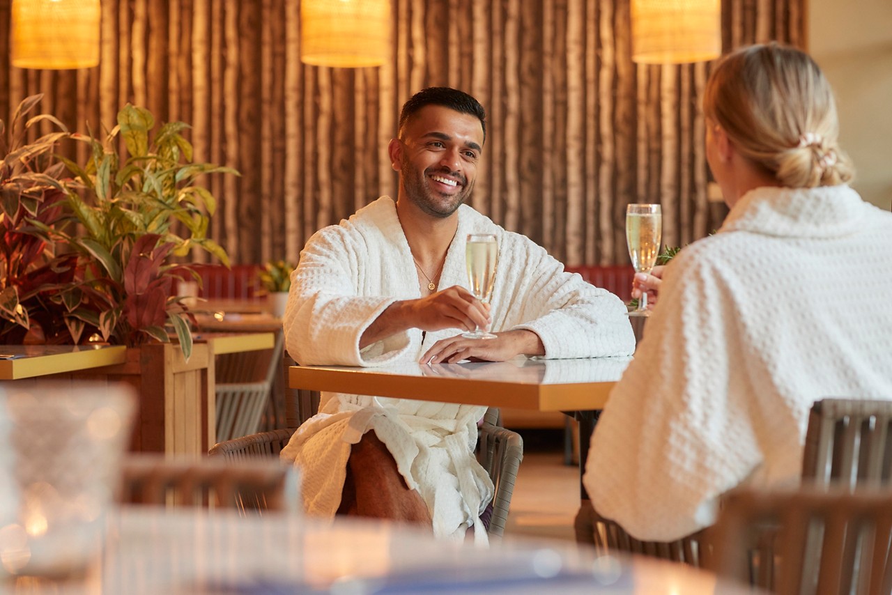 Couple sitting in the Vitalé Café Bar drinking champagne.