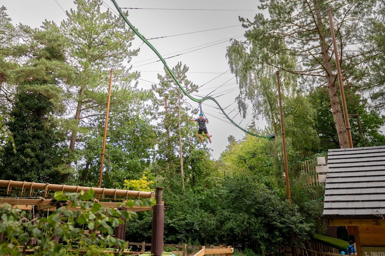 Man gliding across the Treetop Glider.