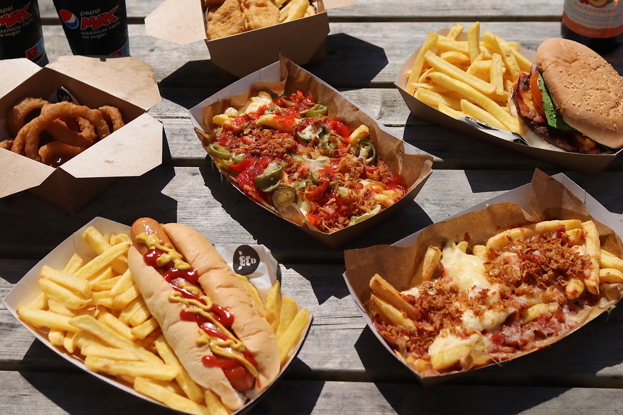 A selection of meals including, loaded fries, hot dogs and burgers.