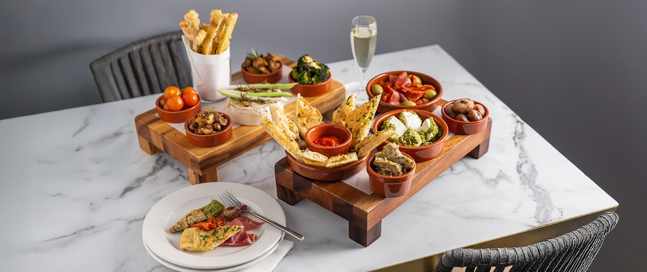 Sharing platter with dips and flatbreads.