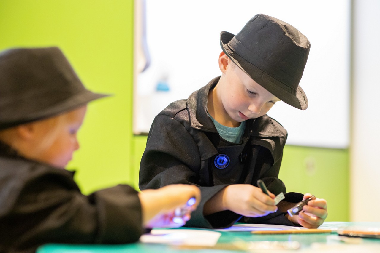 Children dressed as detectives taking part in Spy School.