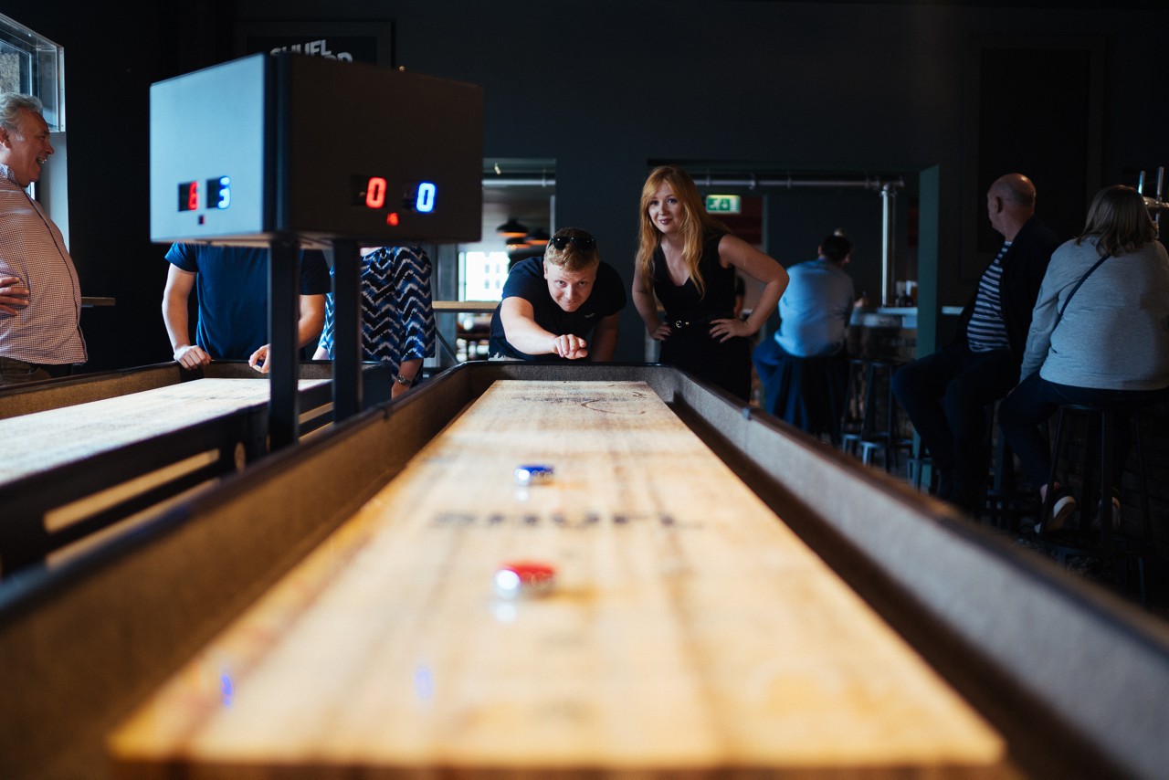 Group playing Interactive Shuffleboard