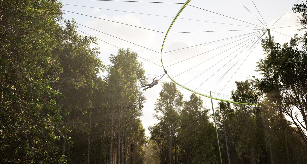 Person suspendend from a track going through the treetops.