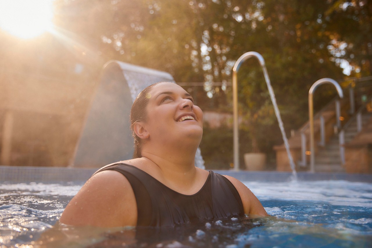 Woman soaking in an outdoor pool.