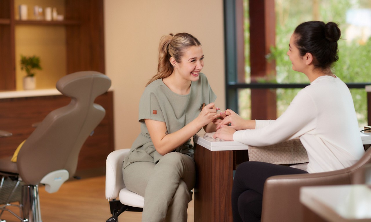 Woman having a manicure from a trained spa therapist.